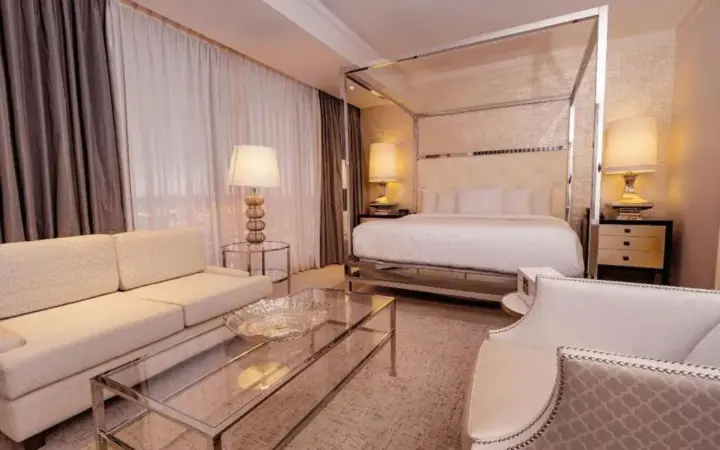 a hotel room with a bed and a couch and a table at Ahern Hotel and Event Center in Las Vegas