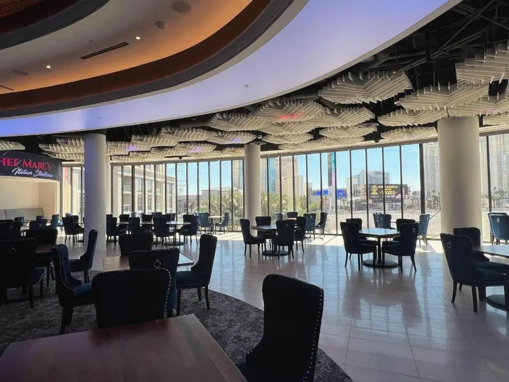 a restaurant with tables and chairs in a building at Ahern Hotel and Event Center in Las Vegas