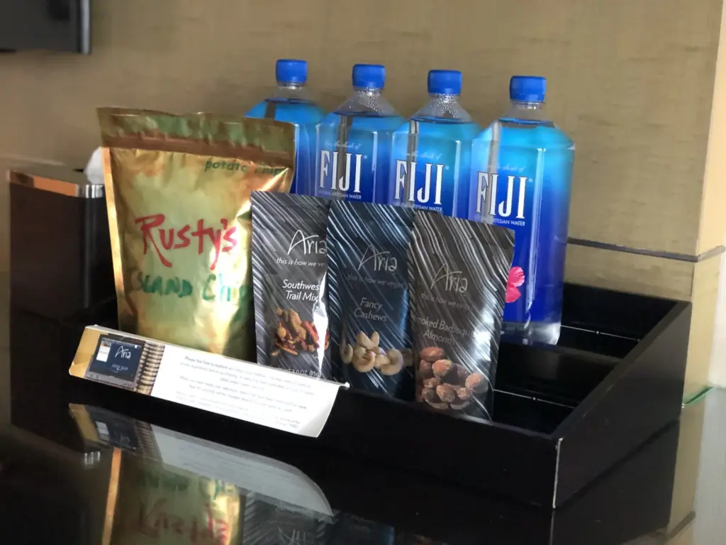 Minibar snacks and bottled water in a hotel room at ARIA Las Vegas