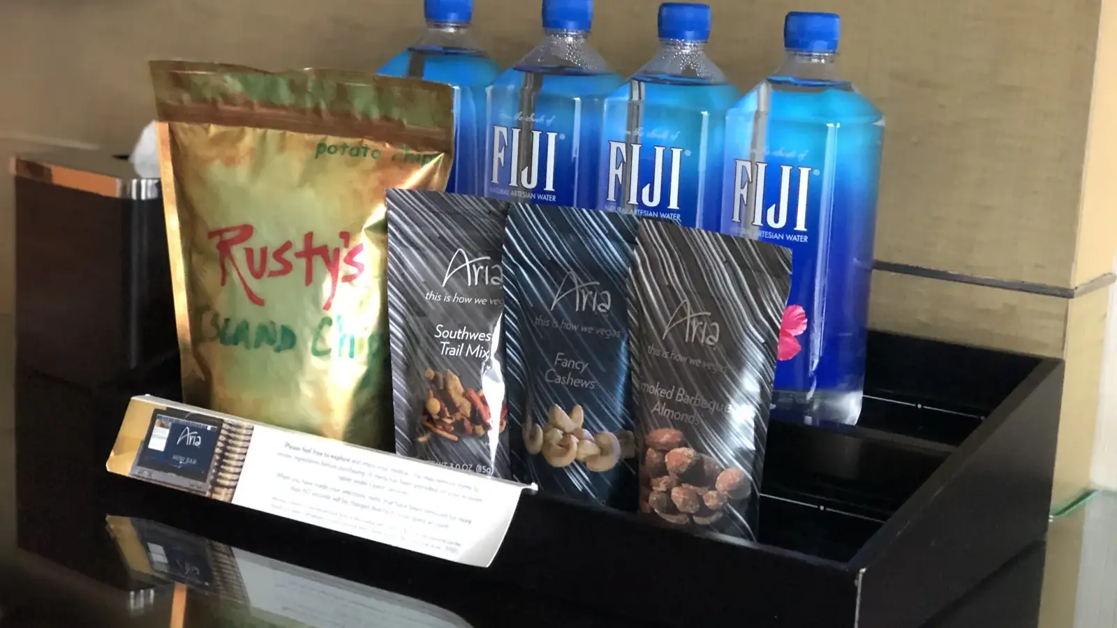 Minibar snacks and bottled water in a hotel room at ARIA Las Vegas