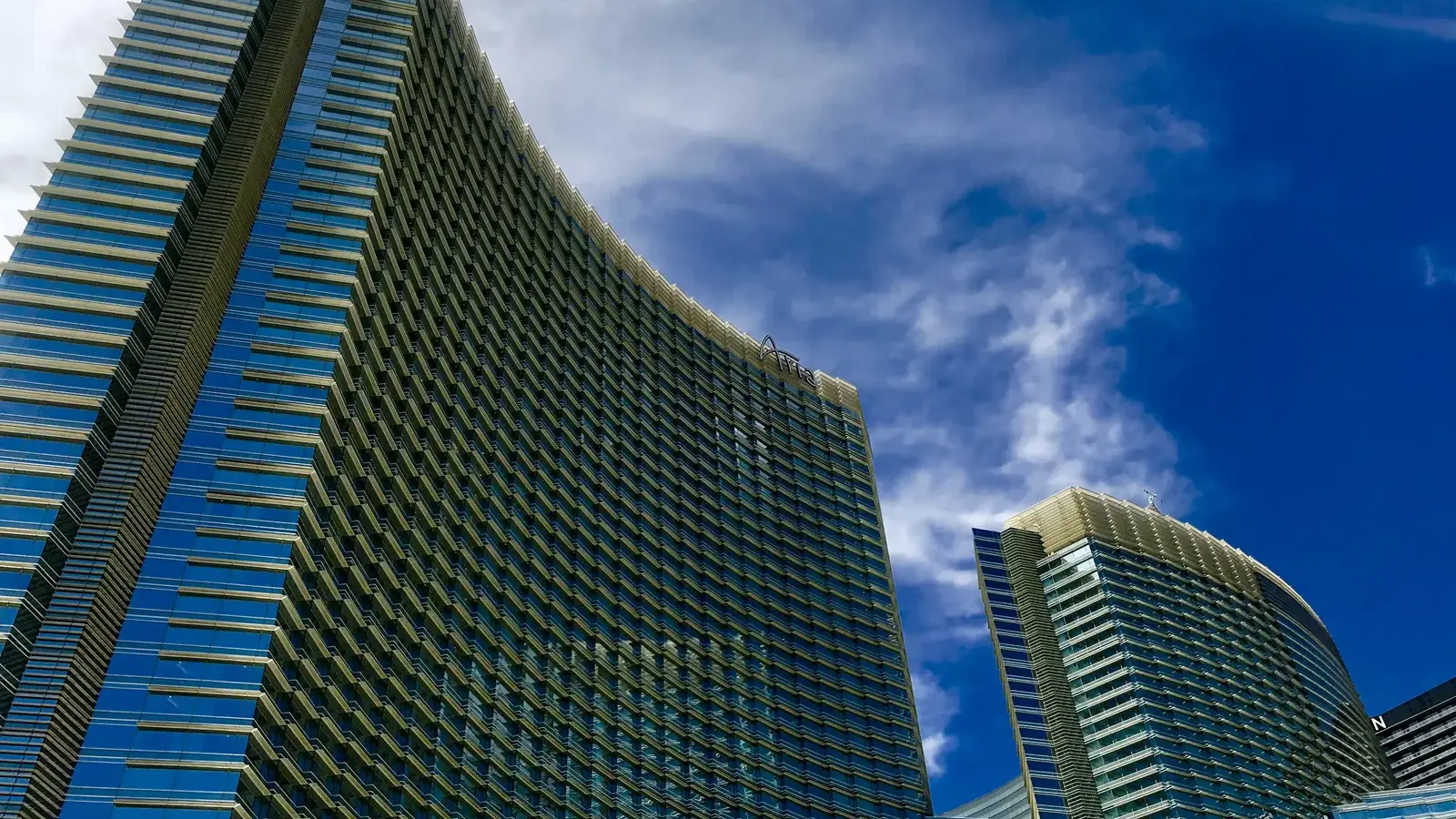 ARIA Resort & Casino's curved glass towers against a blue sky