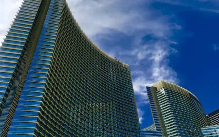 ARIA Resort & Casino's curved glass towers against a blue sky
