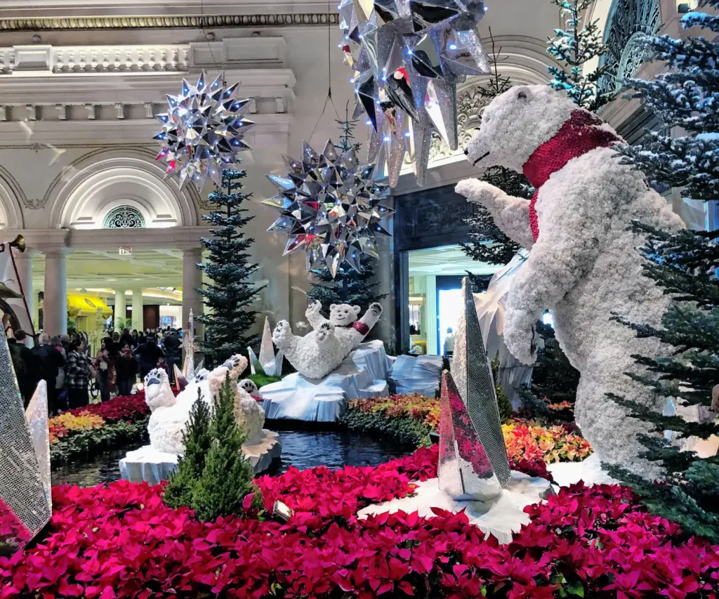 Bellagio Conservatory holiday display with a giant flower polar bear and red poinsettias