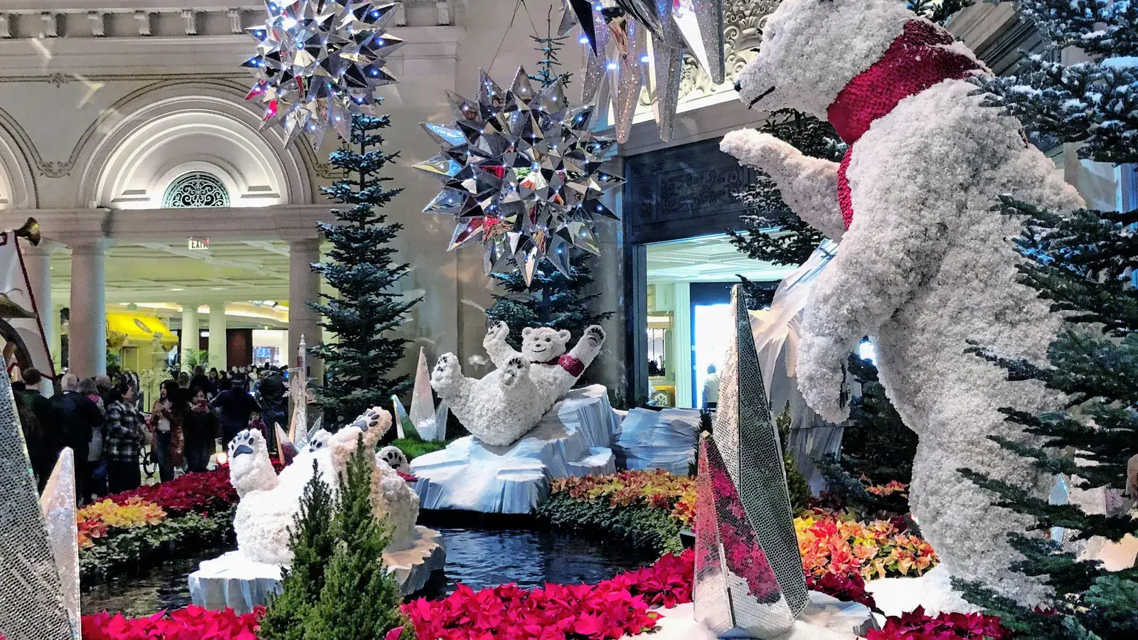 Bellagio Conservatory holiday display with a giant flower polar bear and red poinsettias