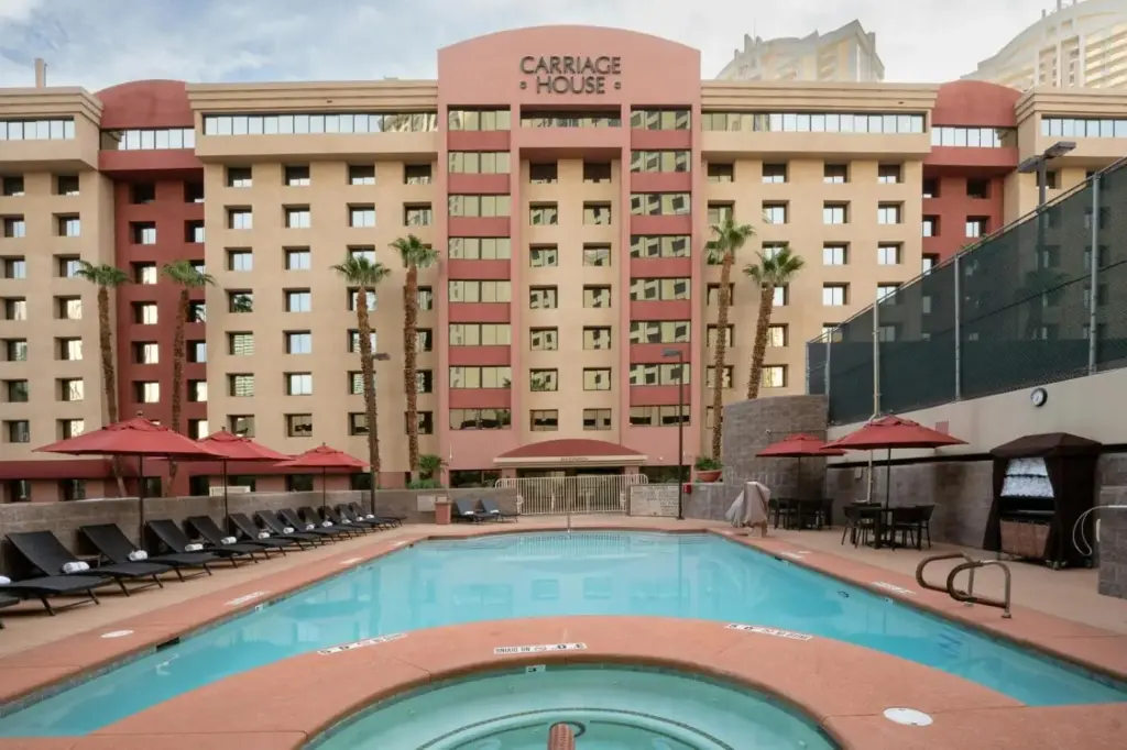 a large swimming pool in front of a hotel at The Carriage House in Las Vegas