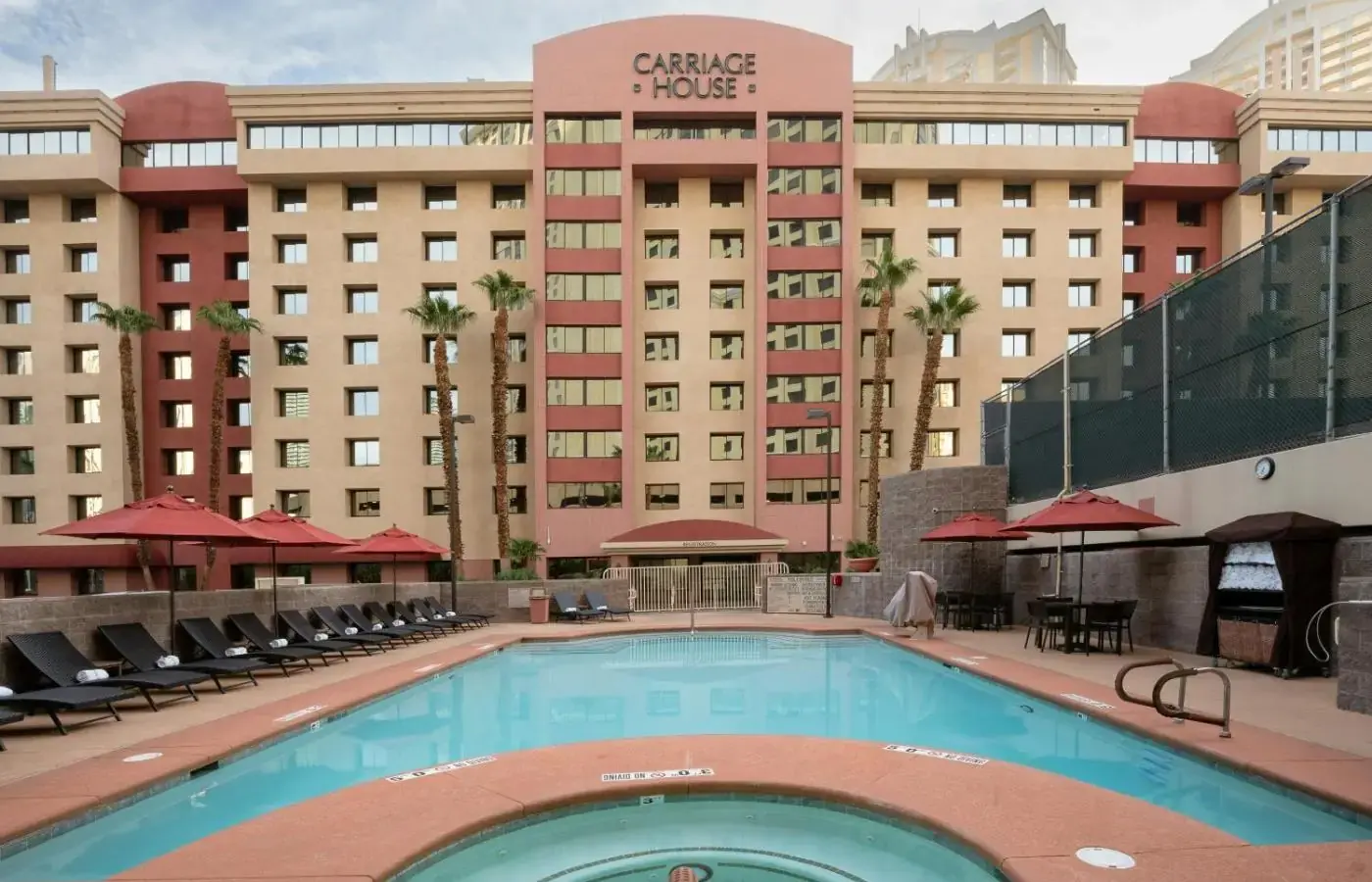 a large swimming pool in front of a hotel at The Carriage House in Las Vegas