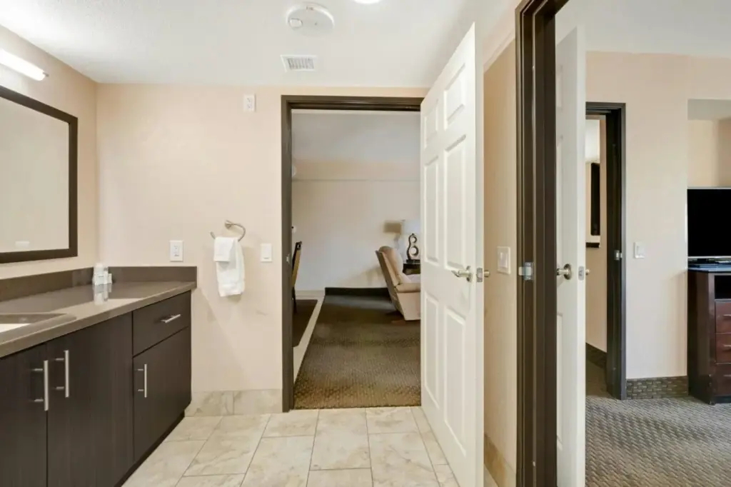 a bathroom with a sink and a mirror at The Carriage House in Las Vegas