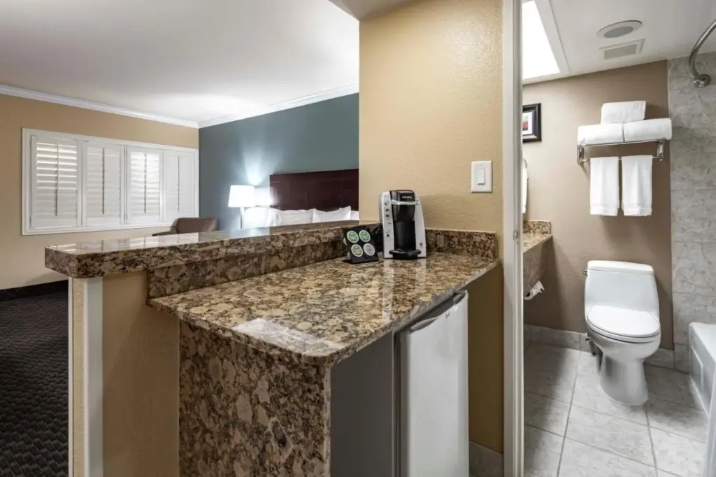 a hotel bathroom with a toilet and a sink at Best Western Plus Casino Royale–Center Strip in Las Vegas