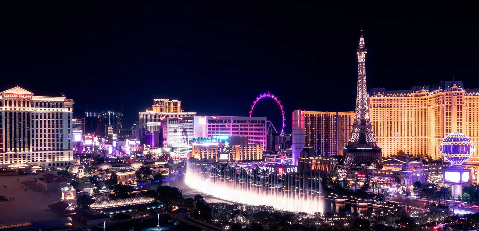 Bellagio's fountains and the center Strip resorts at night