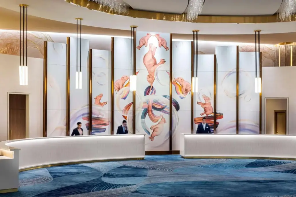 a lobby with a wall mural of fish at Conrad Las Vegas At Resorts World in Las Vegas