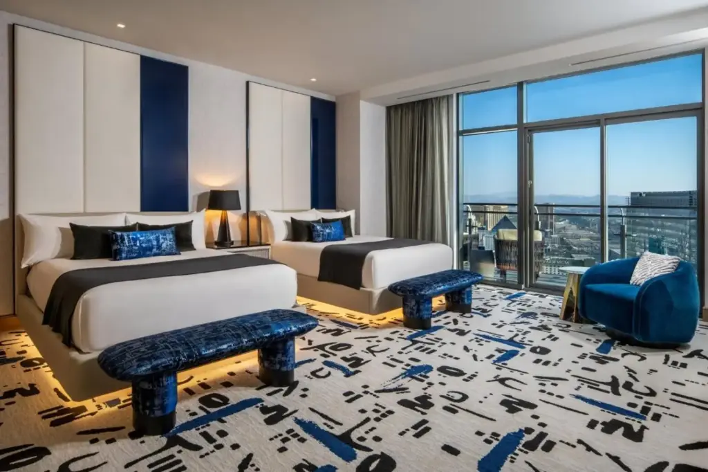two beds in a hotel room with a view at The Cosmopolitan Of Las Vegas in Las Vegas
