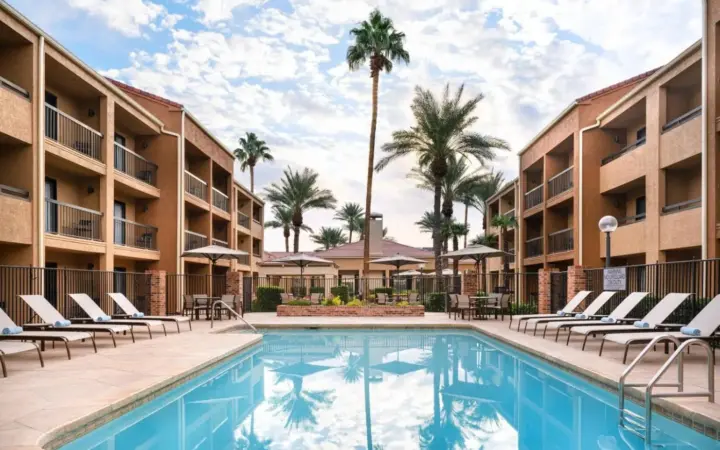 a swimming pool with lounge chairs and a resort at Courtyard by Marriott Las Vegas Convention Center in Las Vegas