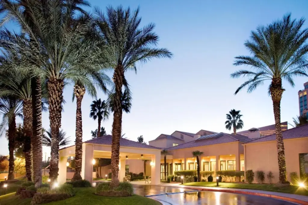 a building with palm trees in front of it at Courtyard by Marriott Las Vegas Convention Center in Las Vegas