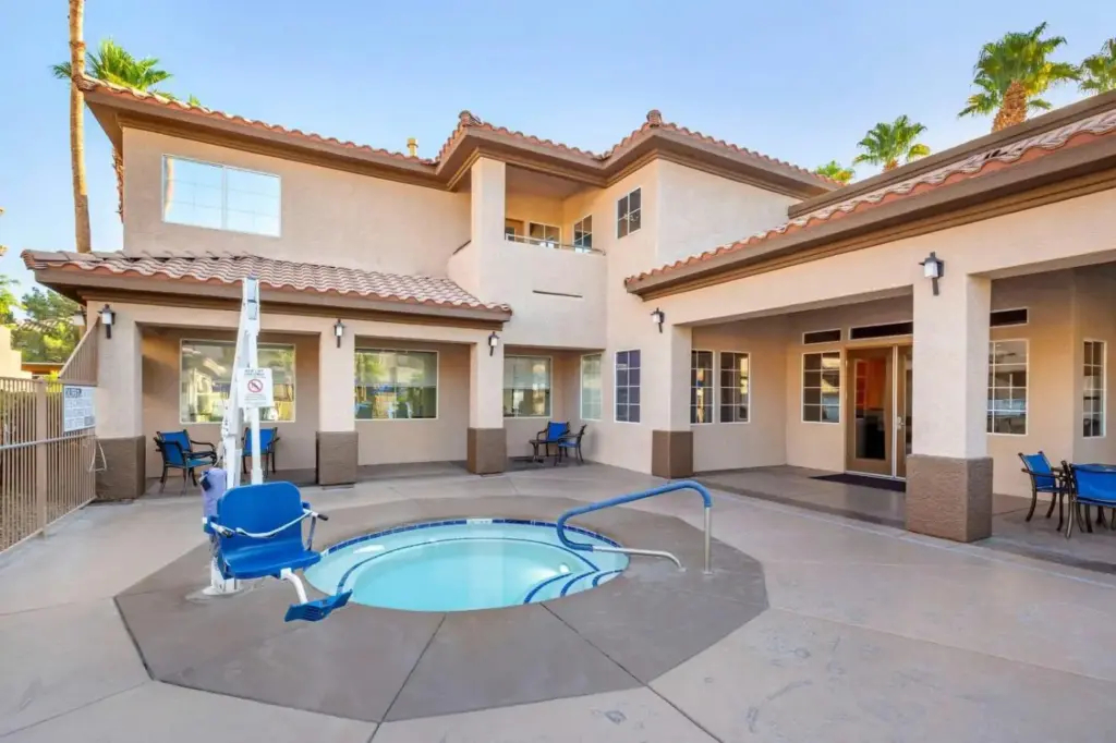 Outdoor hot tub and poolside buildings at Desert Retreat