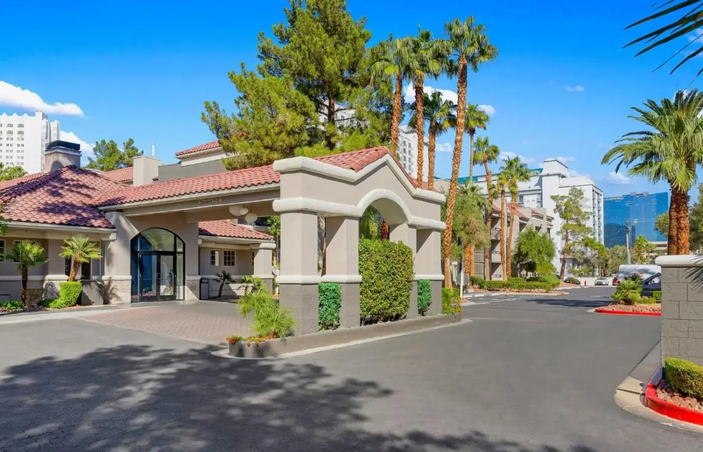 a house with palm trees on a street at Desert Rose Resort in Las Vegas