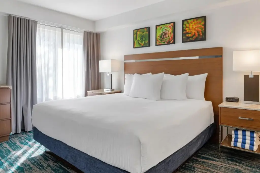 a hotel room with a large bed and a window at Desert Rose Resort in Las Vegas
