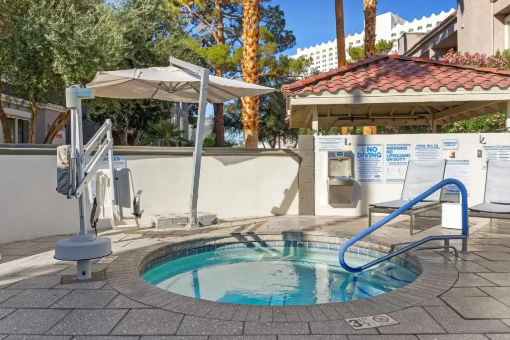 Outdoor hot tub and poolside seating at Desert Rose Resort