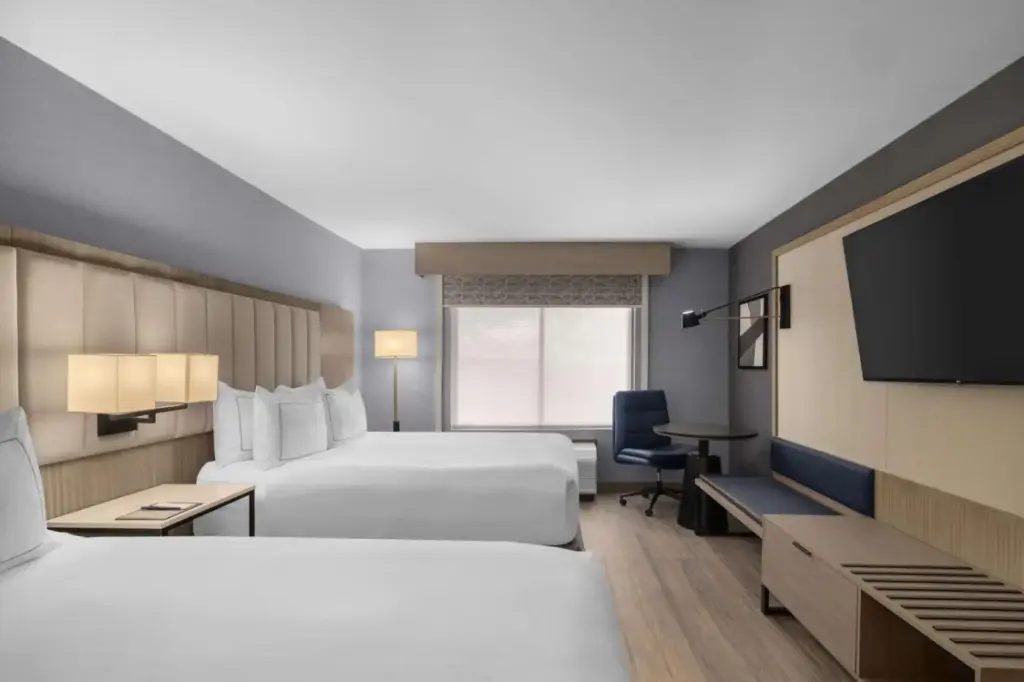 a hotel room with two beds and a flat screen tv at DoubleTree by Hilton Las Vegas Airport in Las Vegas