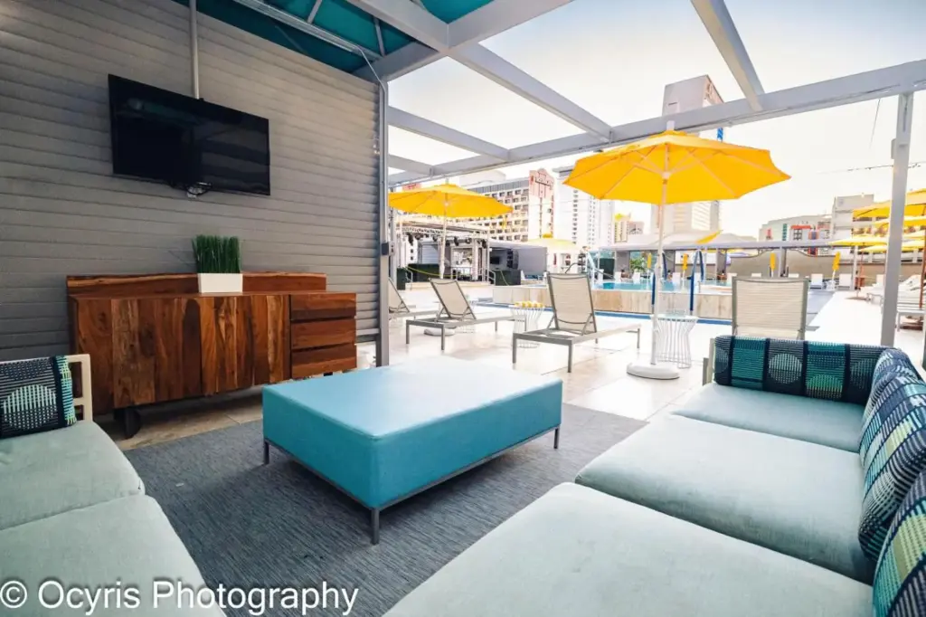 a living room with two couches and a tv on a patio at Downtown Grand Hotel & Casino in Las Vegas