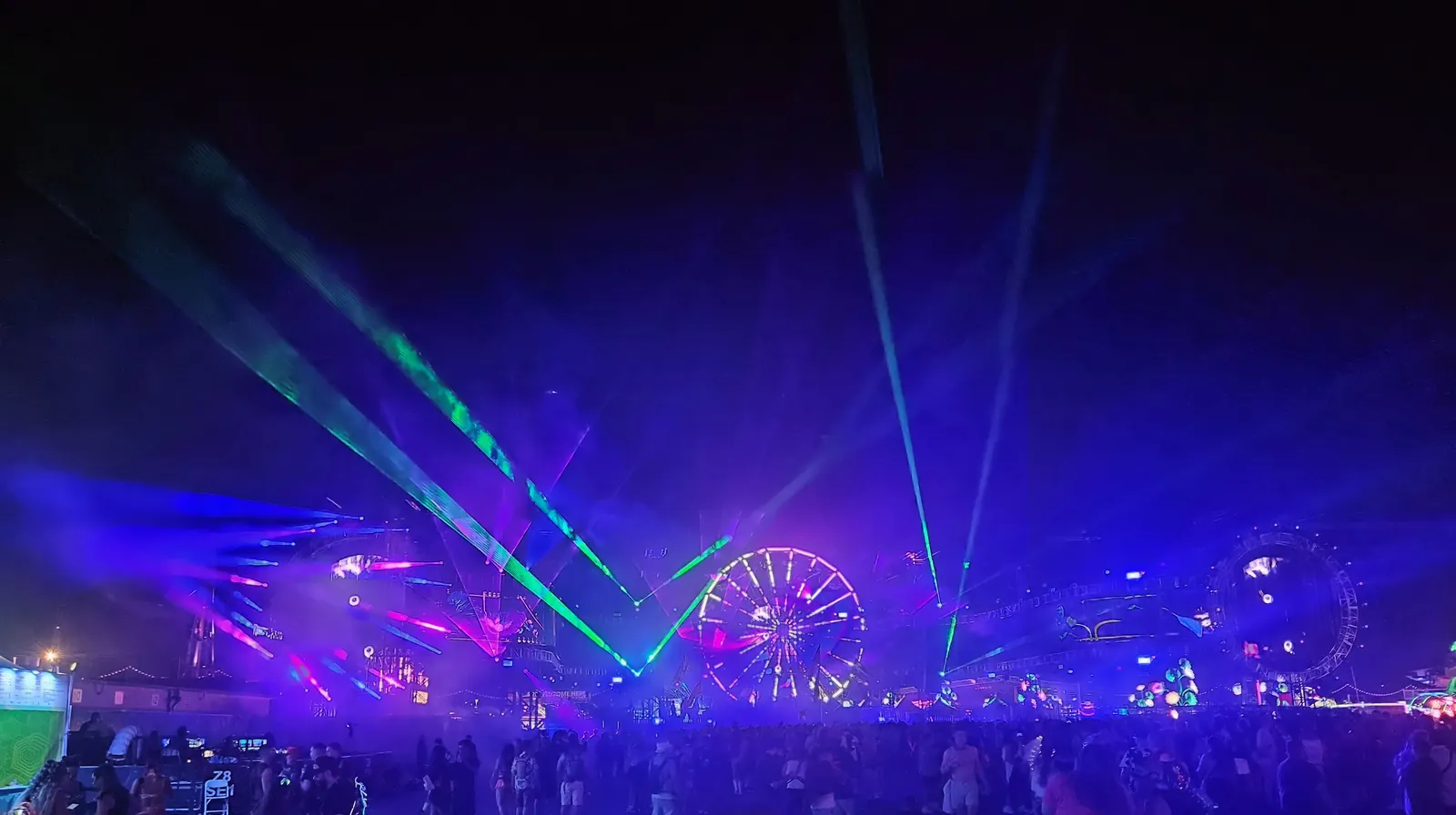 Lasers and the Ferris wheel lighting up the night at EDC Las Vegas