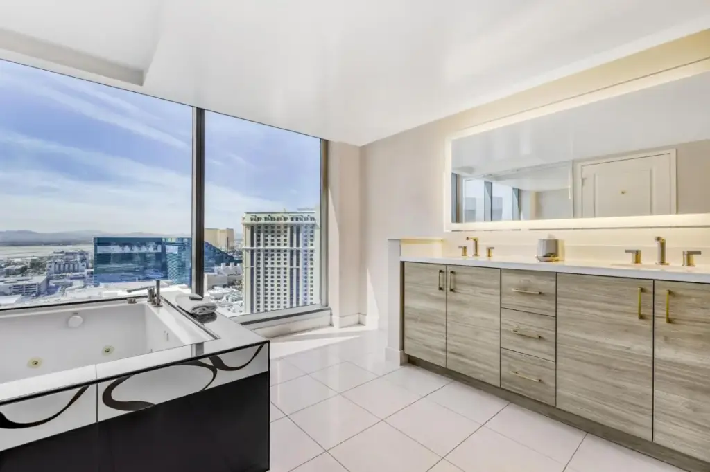 a bathroom with a tub and a large window at Hilton Grand Vacations Club Elara Center Strip Las Vegas in Las Vegas
