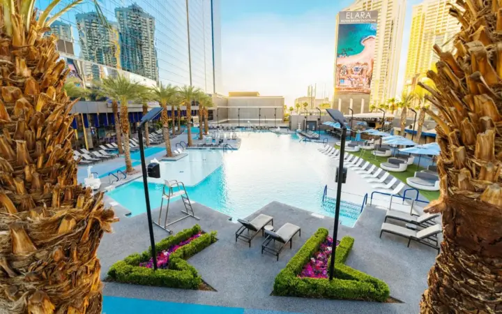 Elara pool with palm trees and hotel towers
