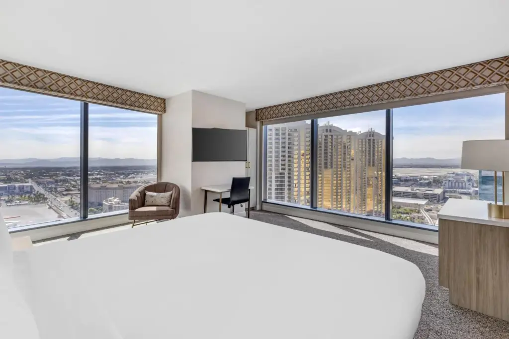Elara bedroom with corner windows and a city view