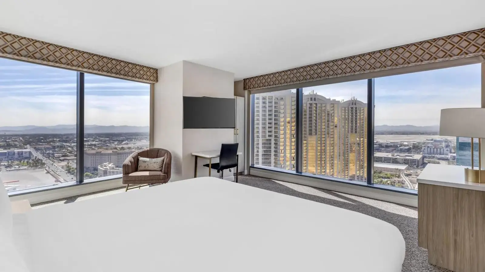 Elara bedroom with corner windows and a city view