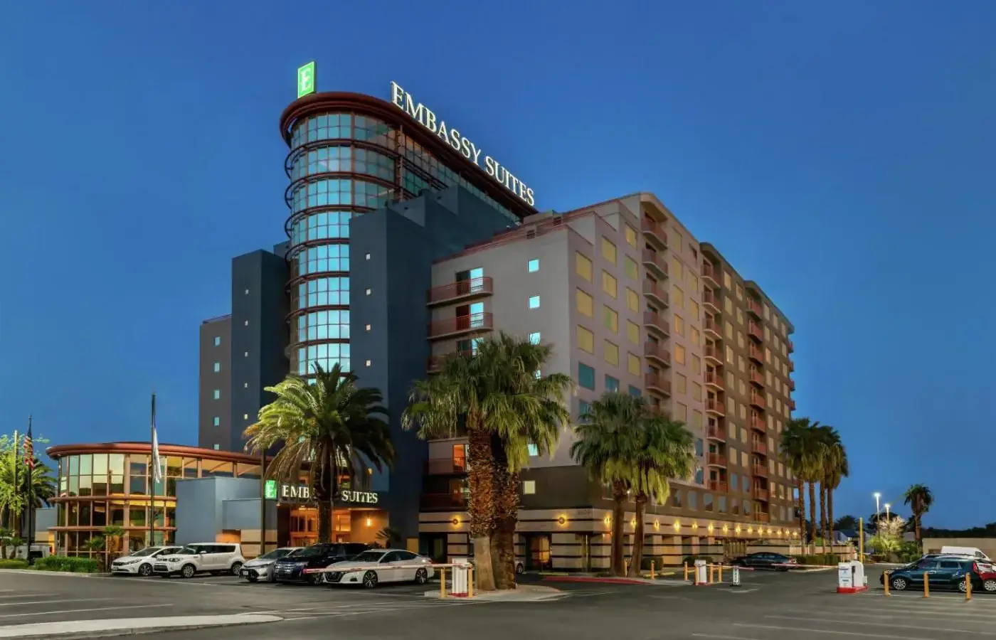 a building with cars parked in a parking lot at Embassy Suites by Hilton Convention Center Las Vegas in Las Vegas