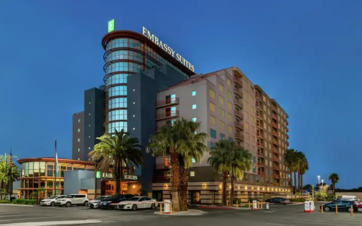 a building with cars parked in a parking lot at Embassy Suites by Hilton Convention Center Las Vegas in Las Vegas