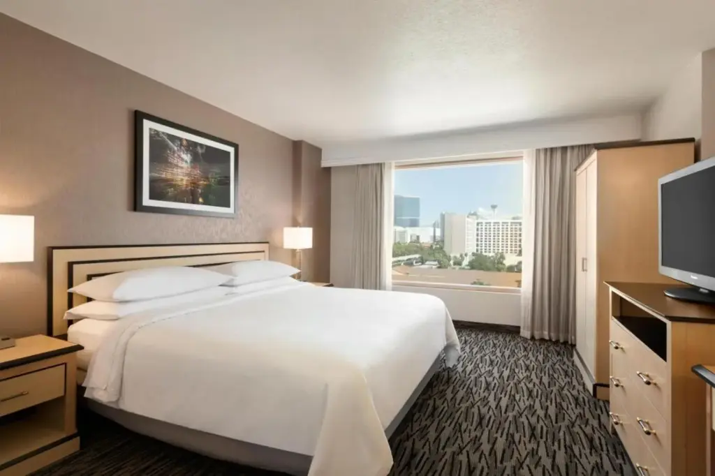 a hotel room with a bed and a large window at Embassy Suites by Hilton Convention Center Las Vegas in Las Vegas