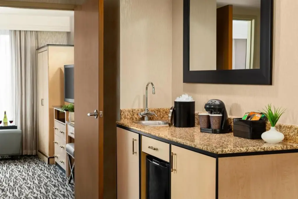 a hotel room with a kitchen with a sink at Embassy Suites by Hilton Convention Center Las Vegas in Las Vegas