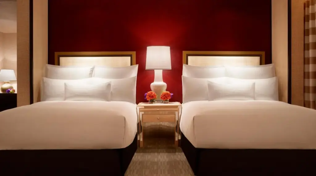 two beds sitting next to each other in a room at Encore at Wynn Las Vegas in Las Vegas