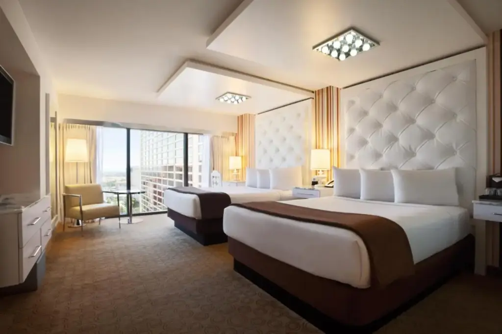 a hotel room with two beds and a balcony at Flamingo Las Vegas Hotel & Casino in Las Vegas