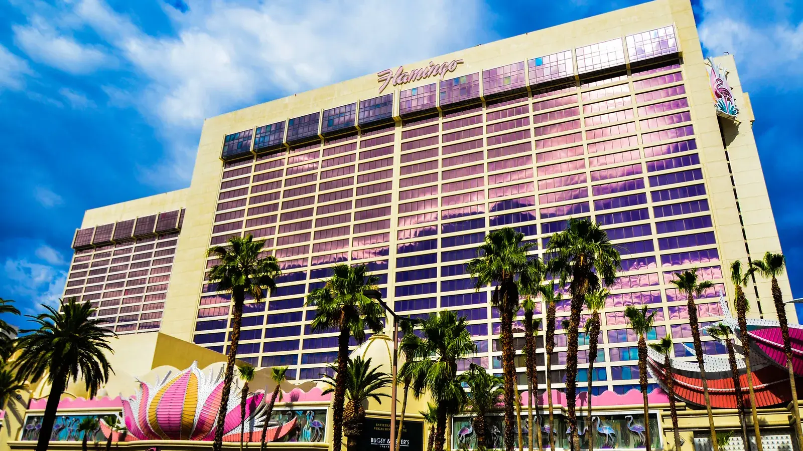 Flamingo Las Vegas hotel tower and pink neon facade with palm trees