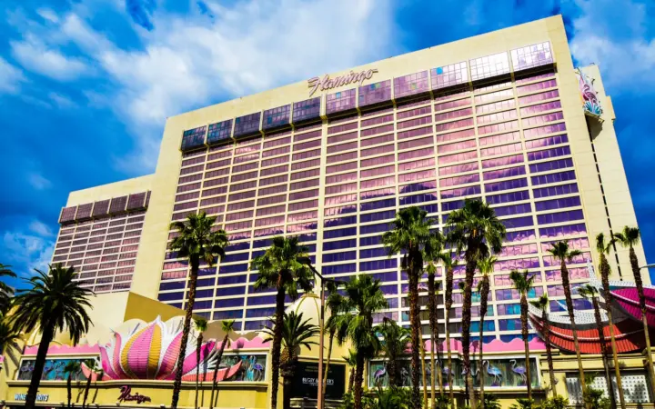 Flamingo Las Vegas hotel tower and pink neon facade with palm trees
