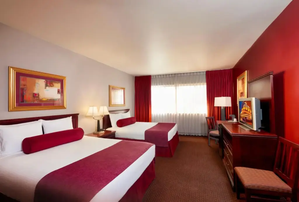 a hotel room with two beds and a television at Four Queens Hotel and Casino in Las Vegas