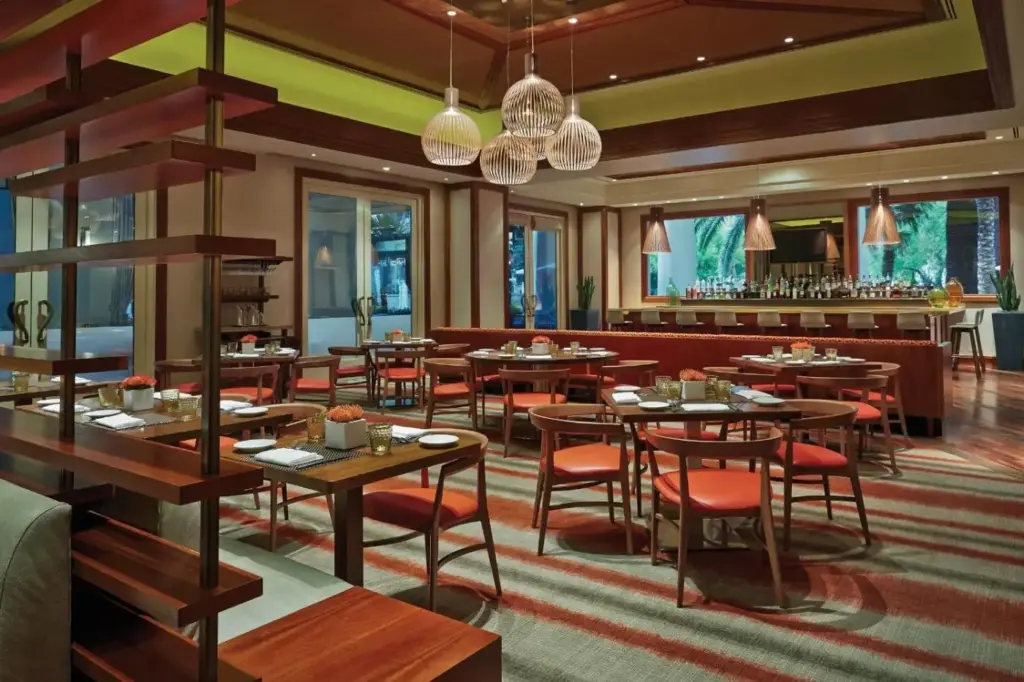 a restaurant with tables and chairs and a bar at Four Seasons Hotel Las Vegas in Las Vegas
