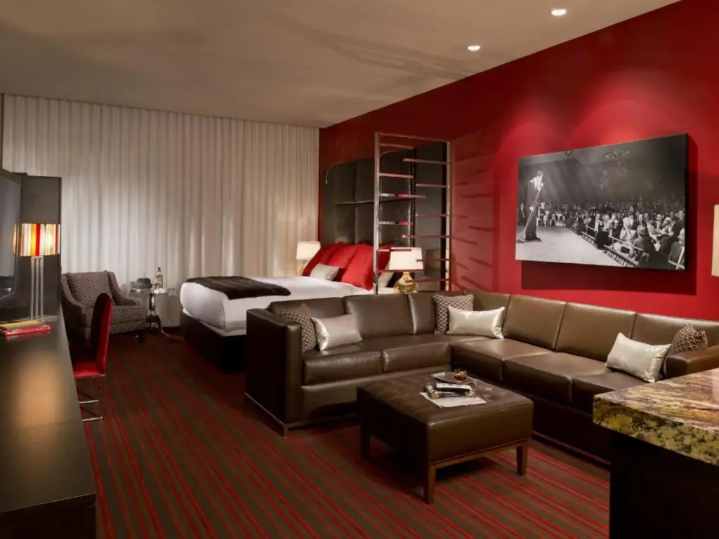 a hotel room with a couch and a bed at Golden Gate Casino Hotel in Las Vegas