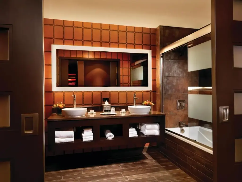 a bathroom with two sinks and a mirror and a tub at Golden Nugget Hotel & Casino Las Vegas in Las Vegas