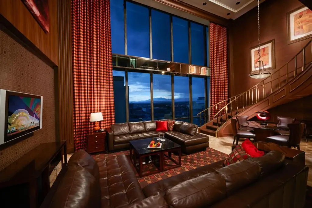 Golden Nugget suite living area with leather sofas and tall windows