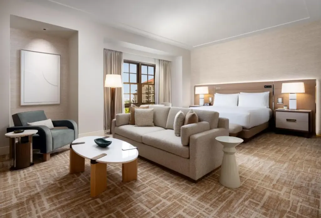 a hotel room with a bed and a couch and chair at Green Valley Ranch Resort Spa Casino in Las Vegas