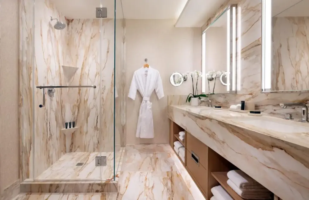 a bathroom with a shower and a robe on a mannequin at Green Valley Ranch Resort Spa Casino in Las Vegas