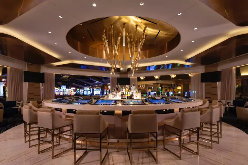 a bar in a casino with chairs and a table at Green Valley Ranch Resort Spa Casino in Las Vegas