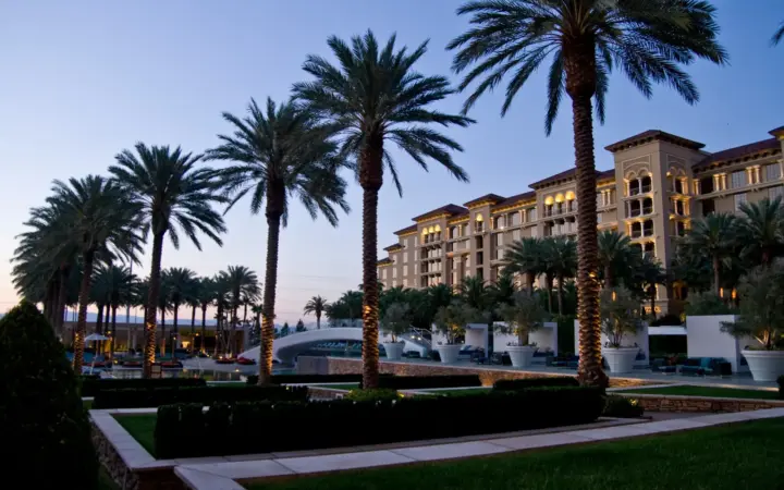 Green Valley Ranch Resort hotel and palm-lined grounds at dusk in Henderson