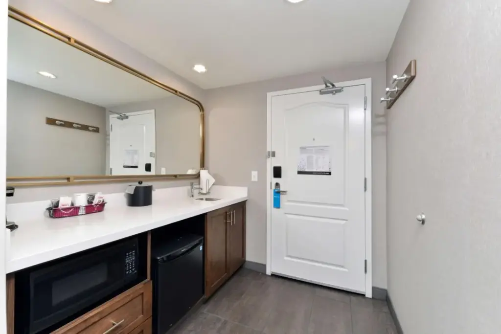 a kitchen with a sink and a mirror at Hampton Inn & Suites Las Vegas Airport in Las Vegas