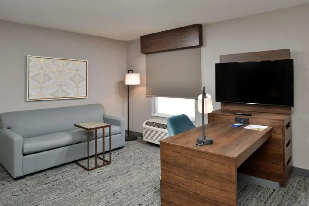 a living room with a couch and a flat screen tv at Hampton Inn & Suites Las Vegas Airport in Las Vegas