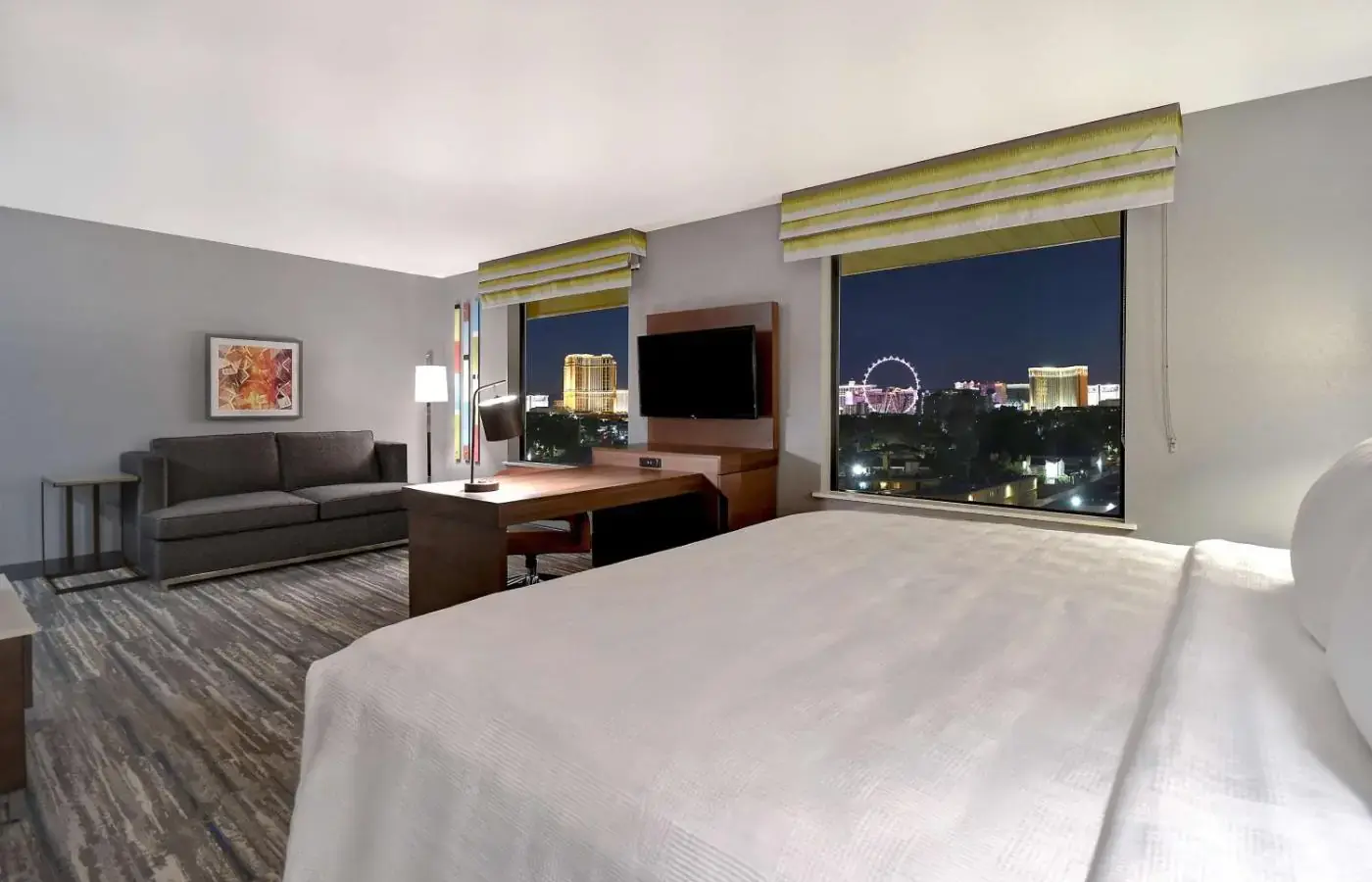 a hotel room with a bed and a large window at Hampton Inn & Suites Las Vegas Convention Center - No Resort Fee in Las Vegas