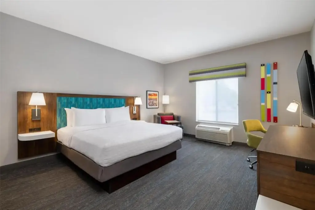 a hotel room with a bed and a desk at Hampton Inn Las Vegas/North Speedway in Las Vegas