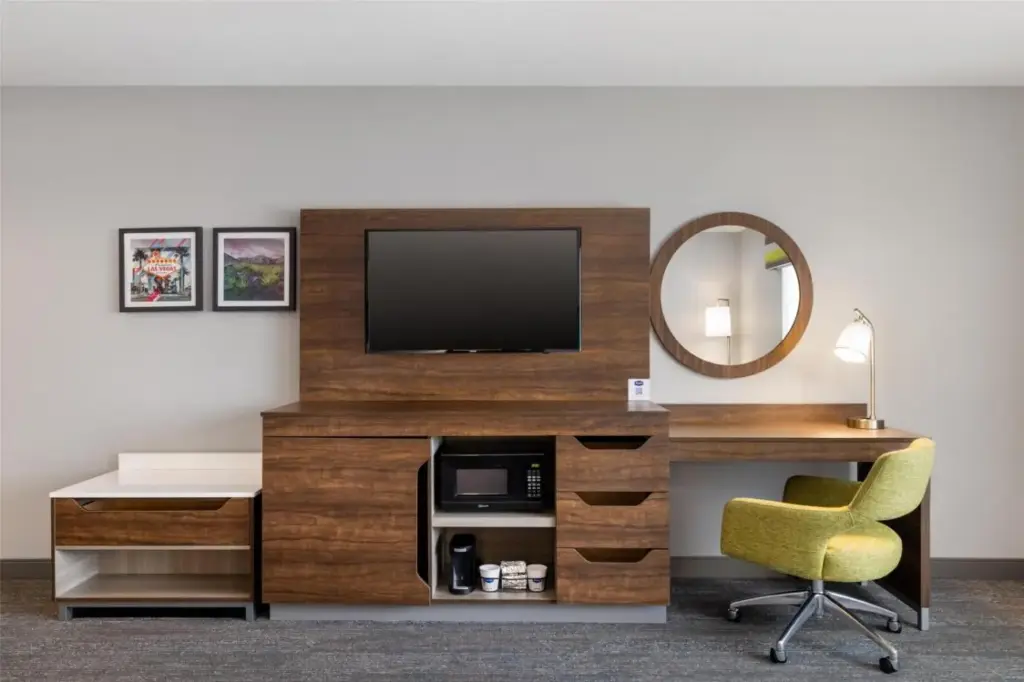 a room with a desk and a television and a chair at Hampton Inn Las Vegas/North Speedway in Las Vegas